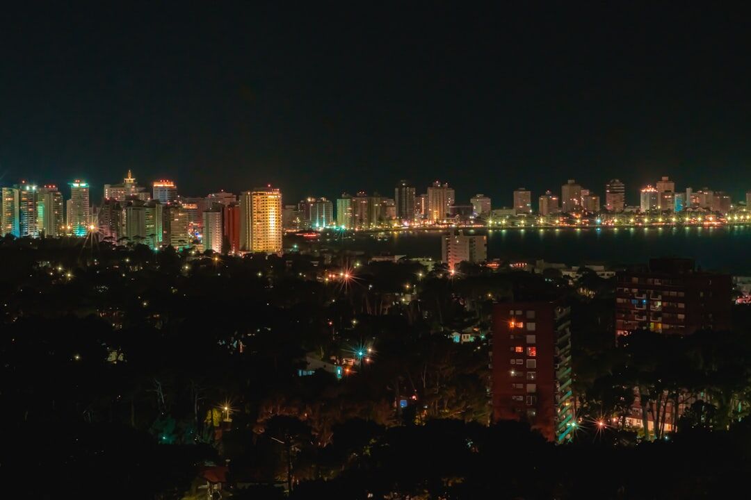 Glamorous nighttime view of Punta del Este waterfront with luxury yachts and glowing city lights