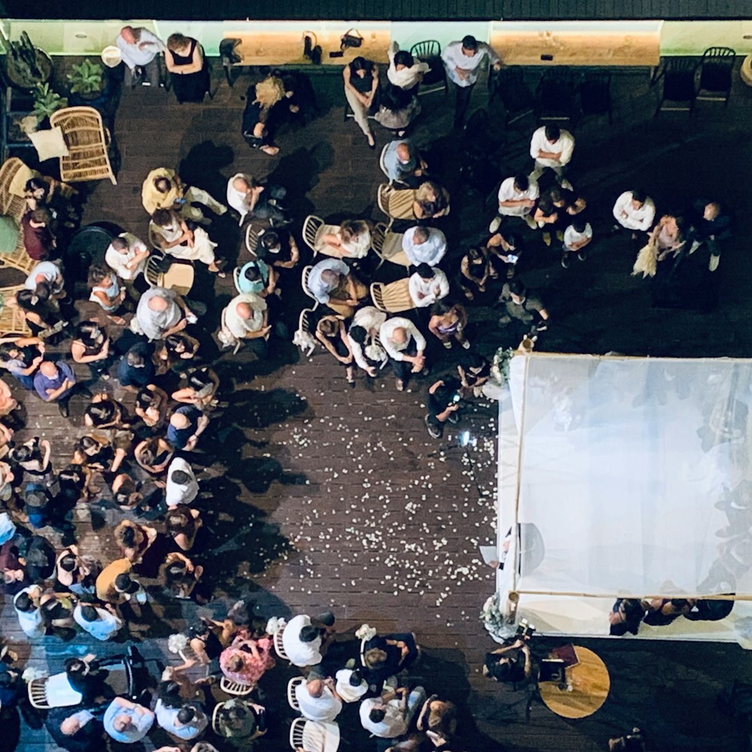 Group of stylish young Latin American friends laughing at a rooftop party