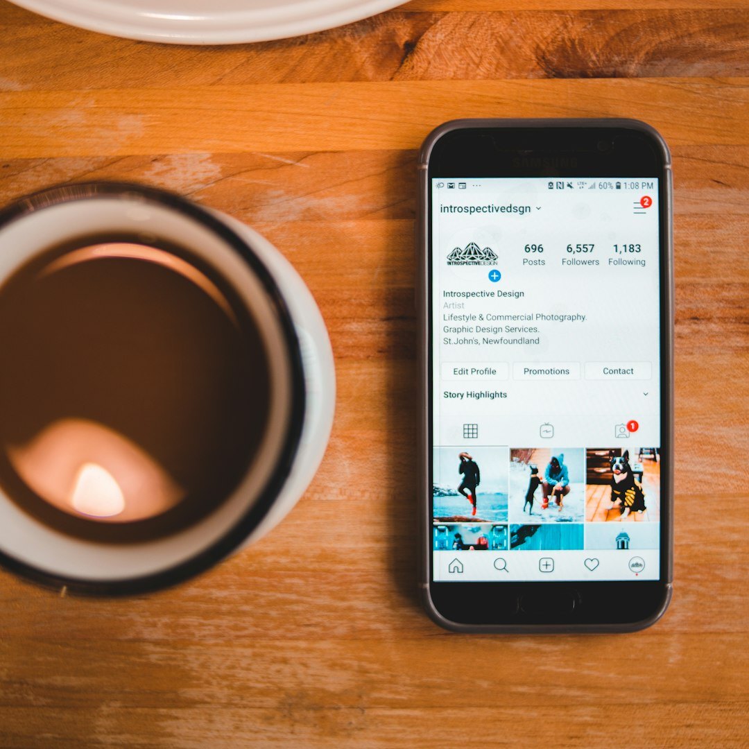 Close up of a smartphone showing a social feed with celebrity photos