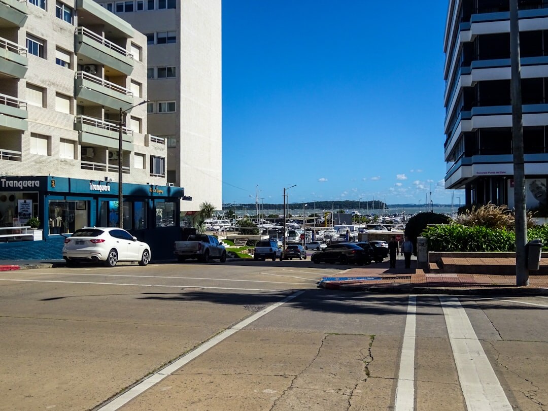 Luxury sports car parked at a marina in Punta del Este
